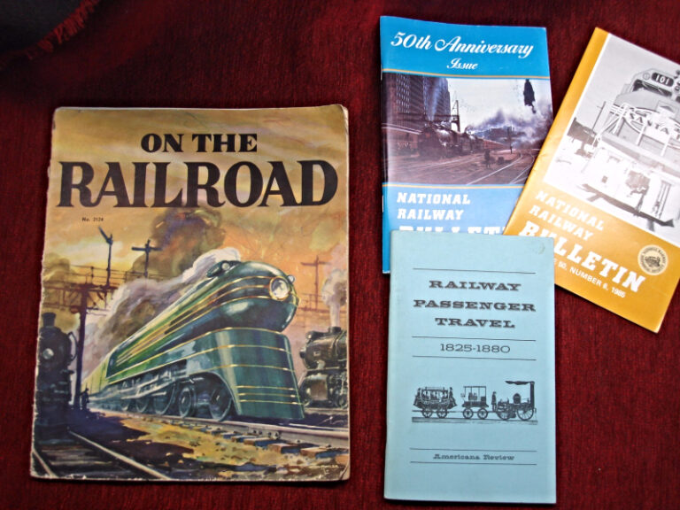 Set of four vintage railroad-themed books for children and adults.