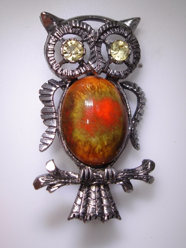 Vintage 1970s owl pin with mottled glass body and rhinestone eyes