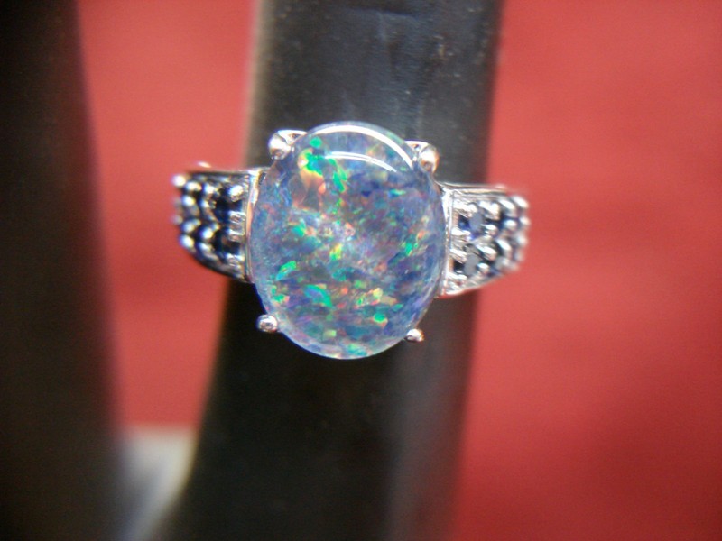 Sterling silver ring with blue sapphires and faux opal center stone