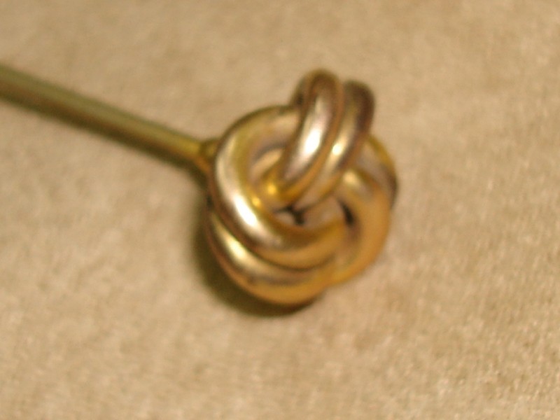 Antique Victorian gold washed hat pin with a unique double knot design