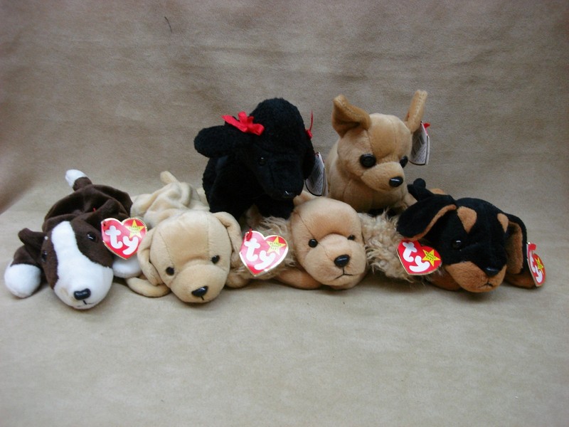 Set of six vintage retired Ty Beanie Babies dogs: Bruno, Gigi, Spunky, Doby, Fetch, and Tiny with original tags.