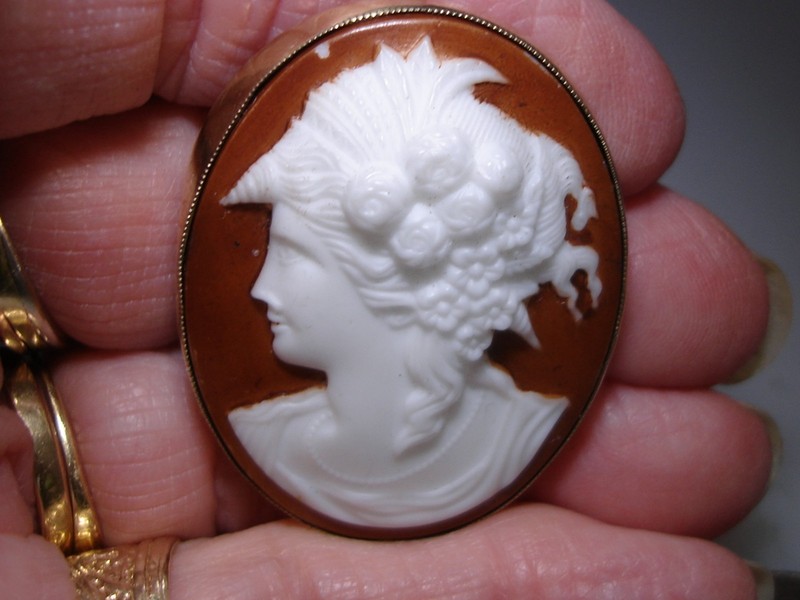 Antique Victorian cameo pin with a molded milk glass cameo set in a gold-filled frame