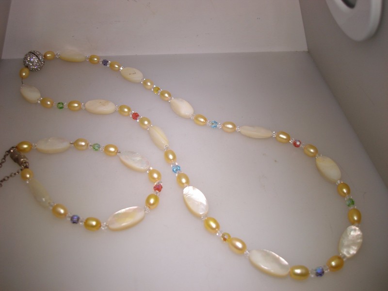 Vintage gold-tone necklace and bracelet set with mother-of-pearl, freshwater pearls, and aurora borealis crystals