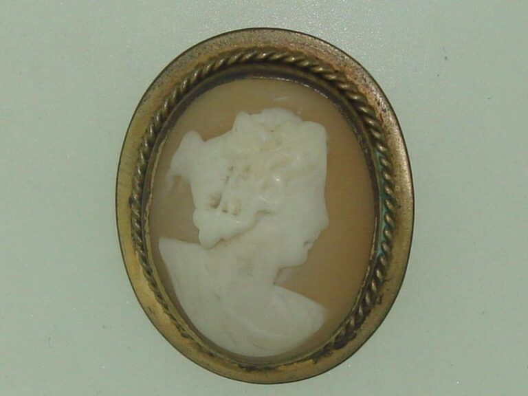 Antique Edwardian gold-washed cameo brooch featuring a carved shell portrait of a young woman