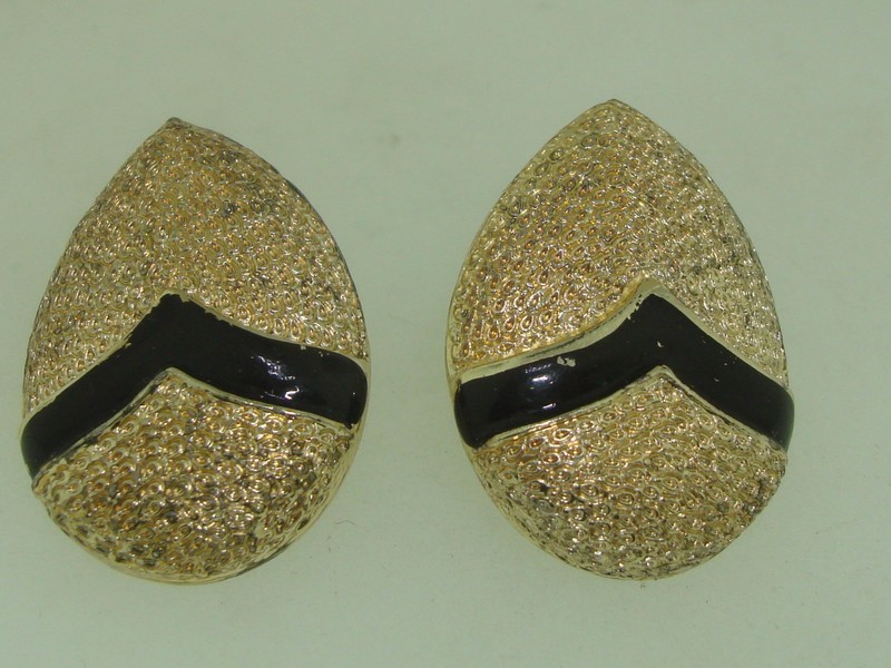 Vintage 1960s Coro clip-on earrings, textured gold tone with black enamel.