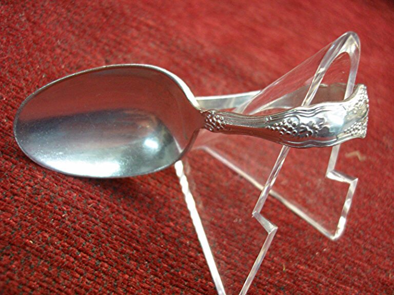 Antique 1847 Rogers Bros. silverplate baby spoon with a curved handle.