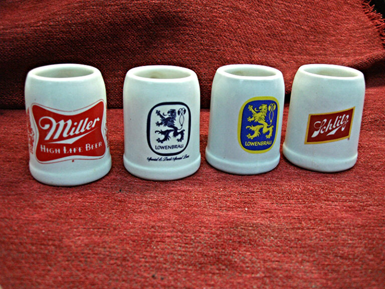 Set of four vintage mini ceramic beer mugs featuring Miller High Life and Löwenbrau Schiltz designs.