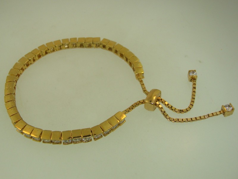 Gold-tone sparkling cubic zirconia tennis bracelet with adjustable slider