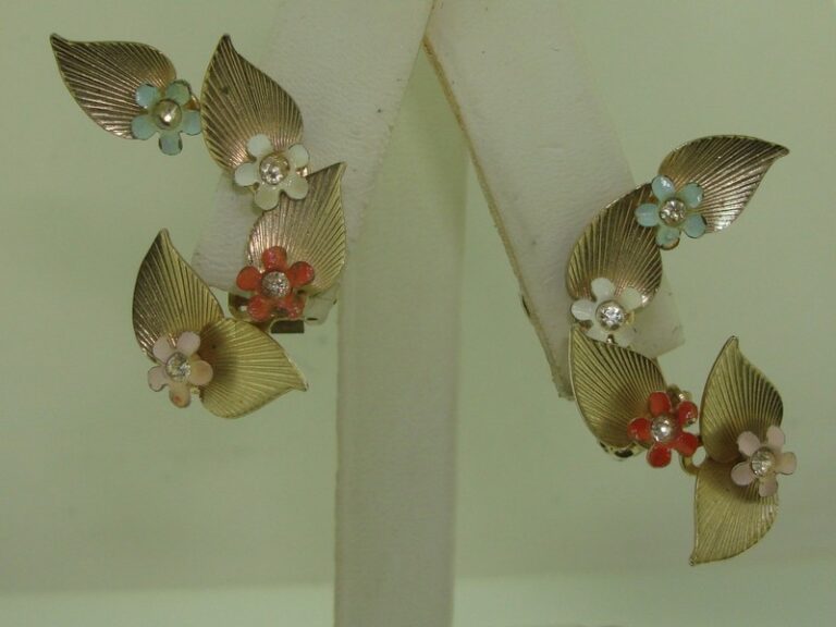Vintage 1950s clip-on floral earrings with enamel flowers in pink, coral, white, and blue, accented with rhinestones.