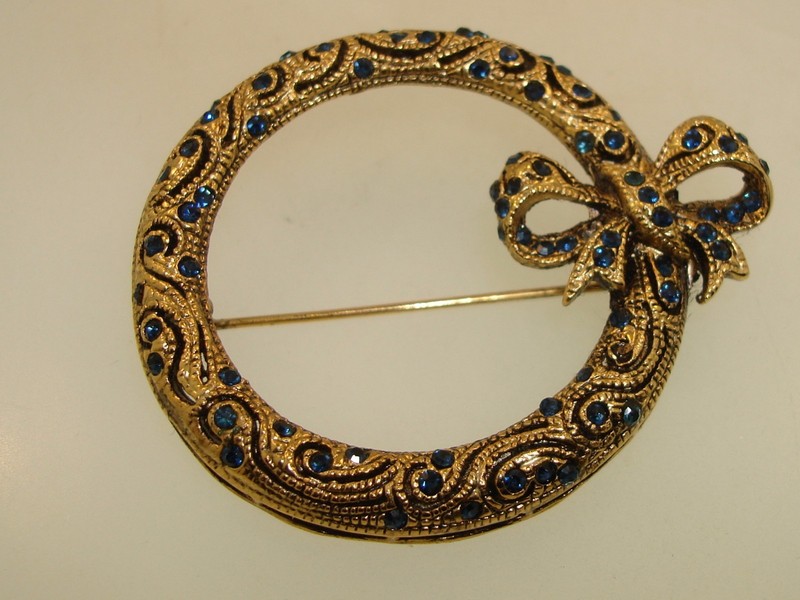 Vintage gold-washed filigree pin with blue rhinestones