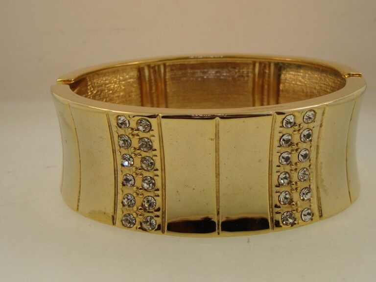 Wide gold tone cuff bracelet with cubic zirconia stones