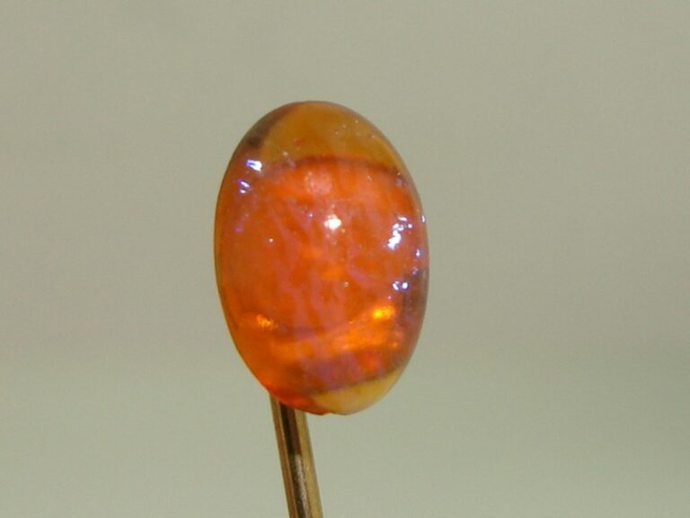 Victorian gold-filled dragon's breath opal stick pin with iridescent blue opal