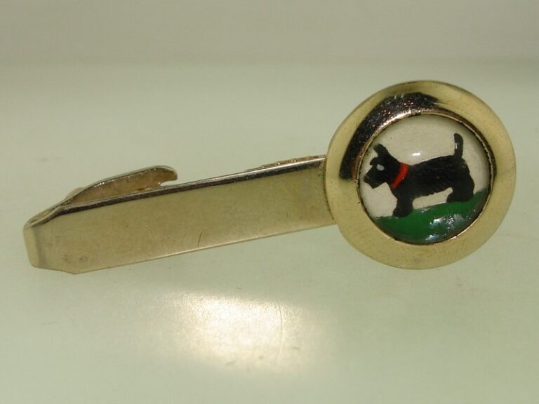 Vintage gold-tone Pioneer Scottie dog tie bar with reverse-carved glass