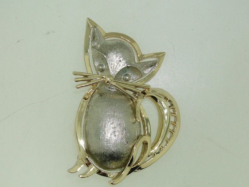 Silver and gold-tone cat pin brooch