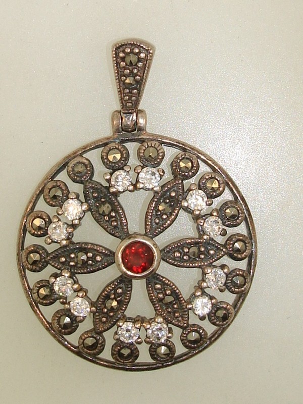 Vintage sterling silver filigree pendant with marcasites, cubic zirconia, and garnet