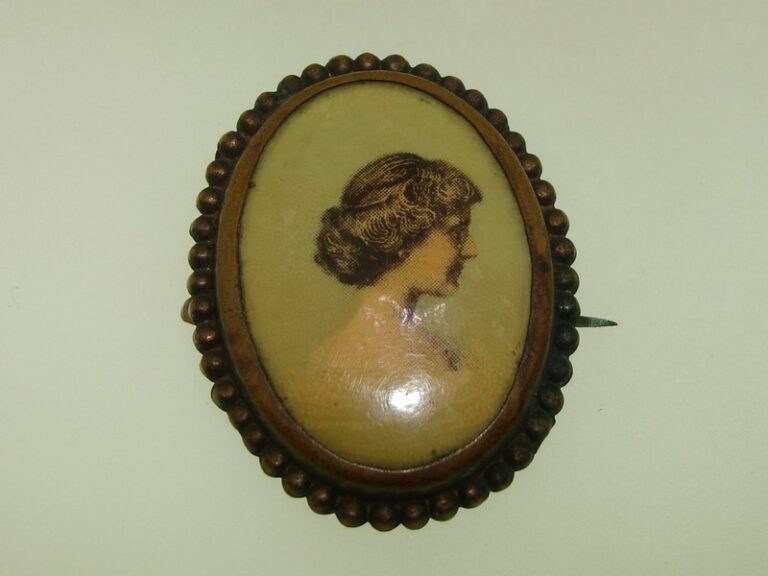 Antique brass cameo photo pin with hand-tinted celluloid portrait of a young woman