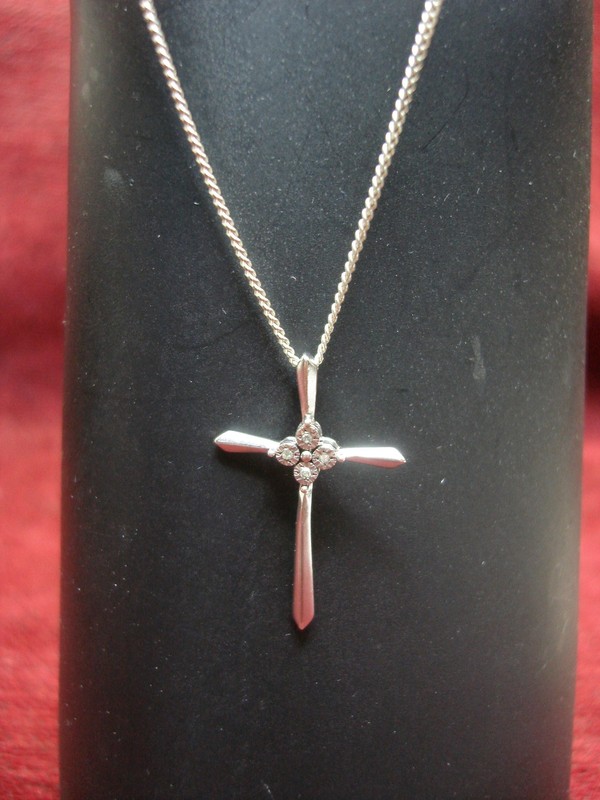 Sterling silver diamond cross necklace with modern design and four accent diamonds