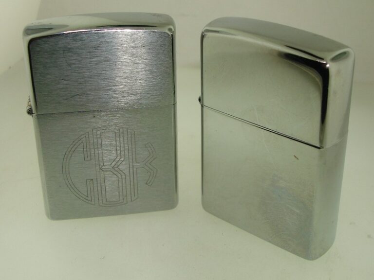Pair of unused 2003 Zippo lighters, one brushed chrome with 'CBK' and '11-22-03' engraving, the other polished chrome with 'Warm Heart Warm Spirit, MS' engraving.