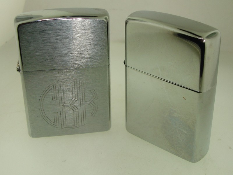 Pair of unused 2003 Zippo lighters, one brushed chrome with 'CBK' and '11-22-03' engraving, the other polished chrome with 'Warm Heart Warm Spirit, MS' engraving.