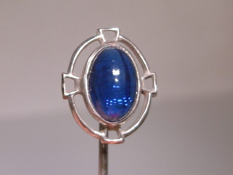 Antique silver art deco stick pin with a blue glass cabochon