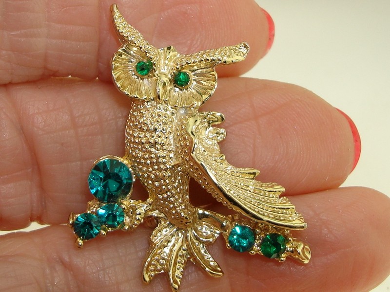Vintage gold-tone owl pin with green rhinestones