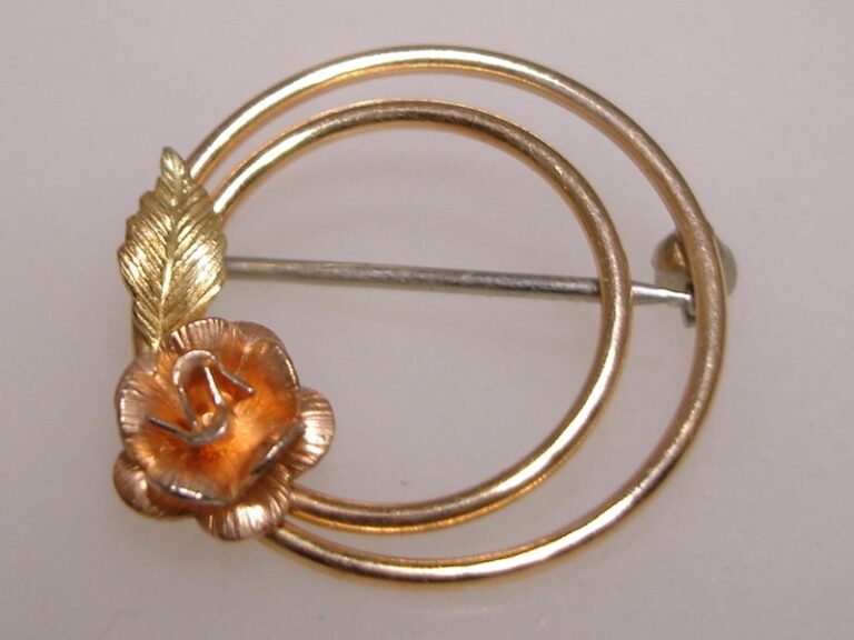 Vintage Krementz rose gold filled pin with green and yellow gold accents and a unique floral design.