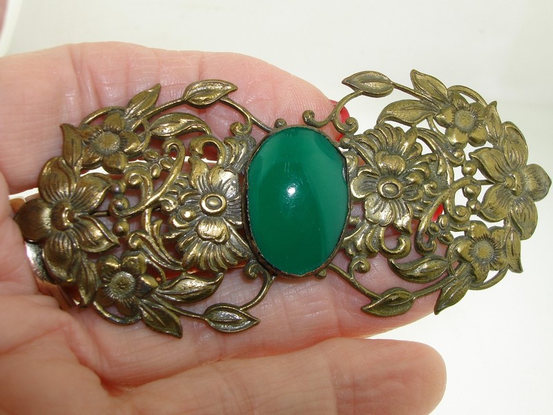 Antique Art Nouveau brass repoussé brooch with green glass cabochon