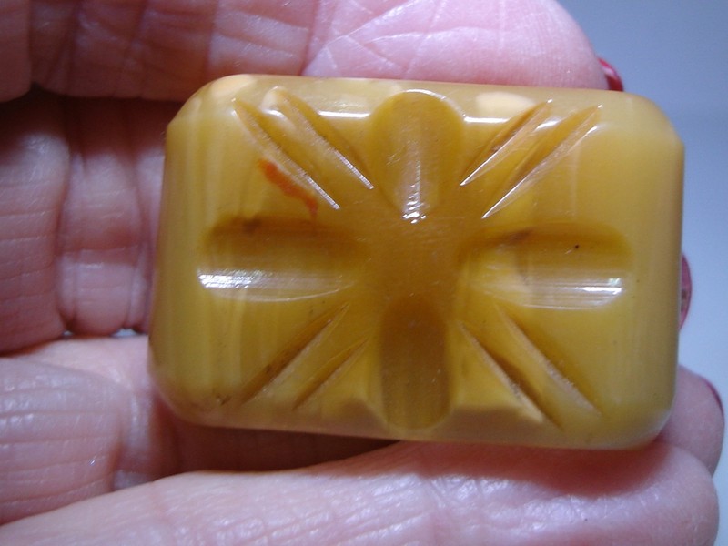 Antique Art Deco bakelite scarf slide with carved design
