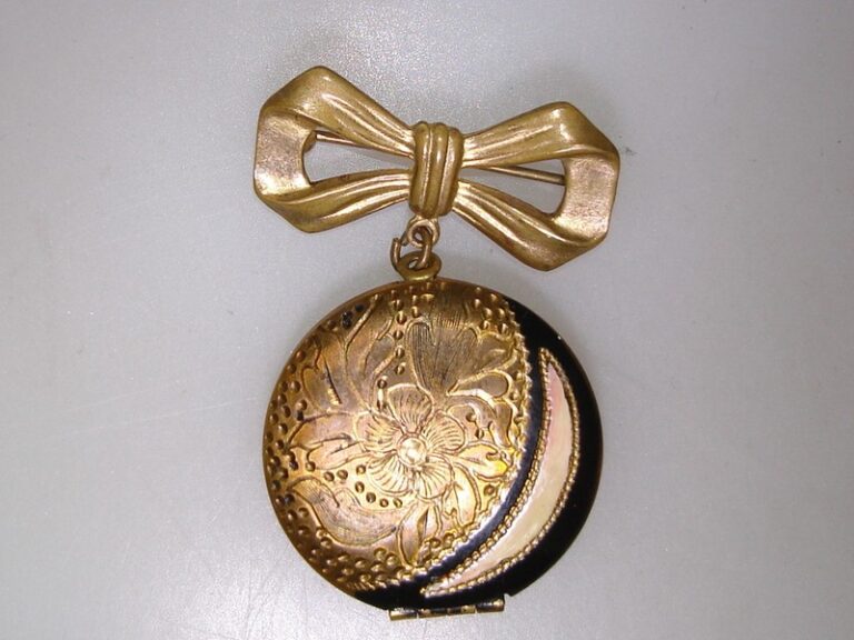 Vintage Art Nouveau locket pin with etched floral design and enamel details, 1920s-30s