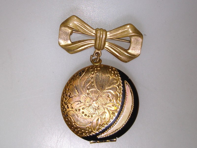 Vintage Art Nouveau locket pin with etched floral design and enamel details, 1920s-30s