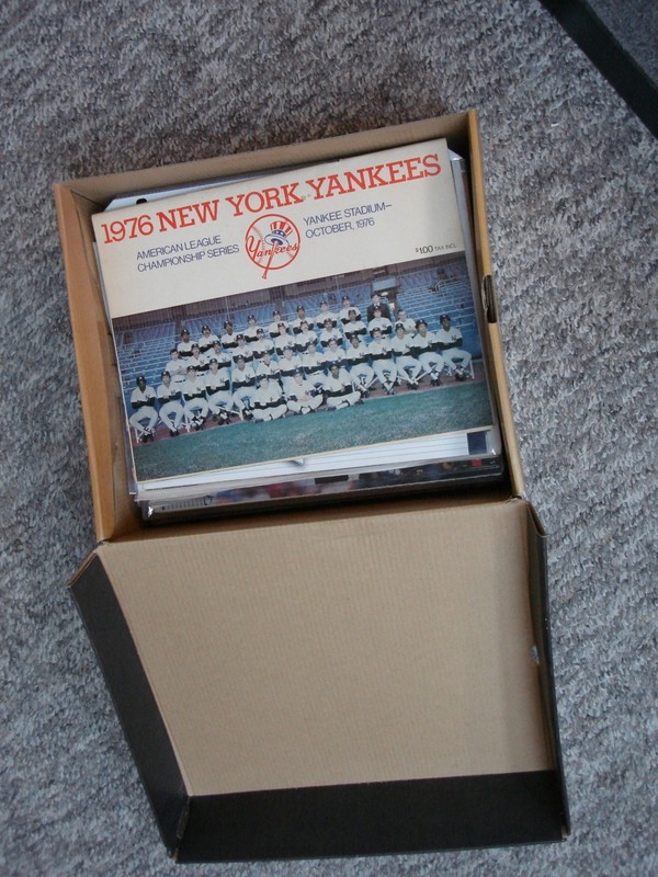 Collection of 13 New York Yankees memorabilia items including yearbooks, Sports Illustrated magazines, and more.
