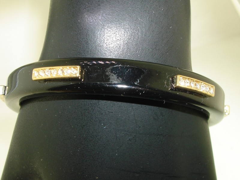 Black lacquer bangle bracelet with gold accents and rhinestones