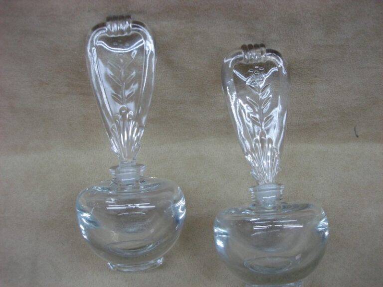 Pair of vintage lead crystal perfume bottles with ornate stoppers