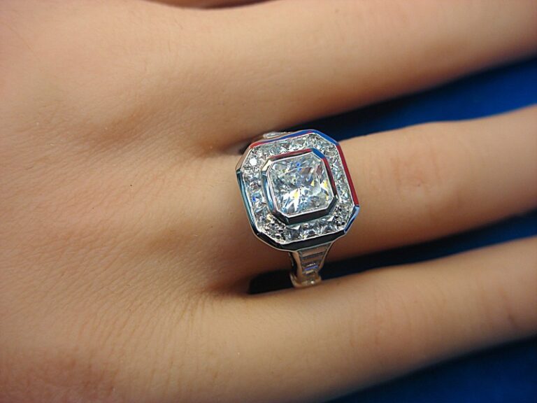 Sterling silver cocktail ring with a large princess-cut cubic zirconia and baguette-cut CZ accents, size 7