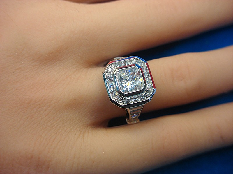 Sterling silver cocktail ring with a large princess-cut cubic zirconia and baguette-cut CZ accents, size 7