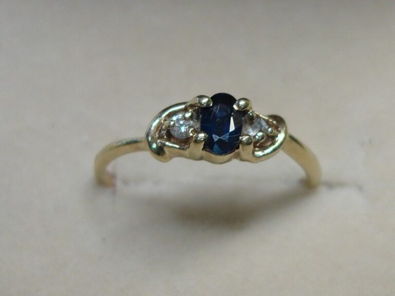 10K gold ring with oval sapphire and diamond accents, size 4.5