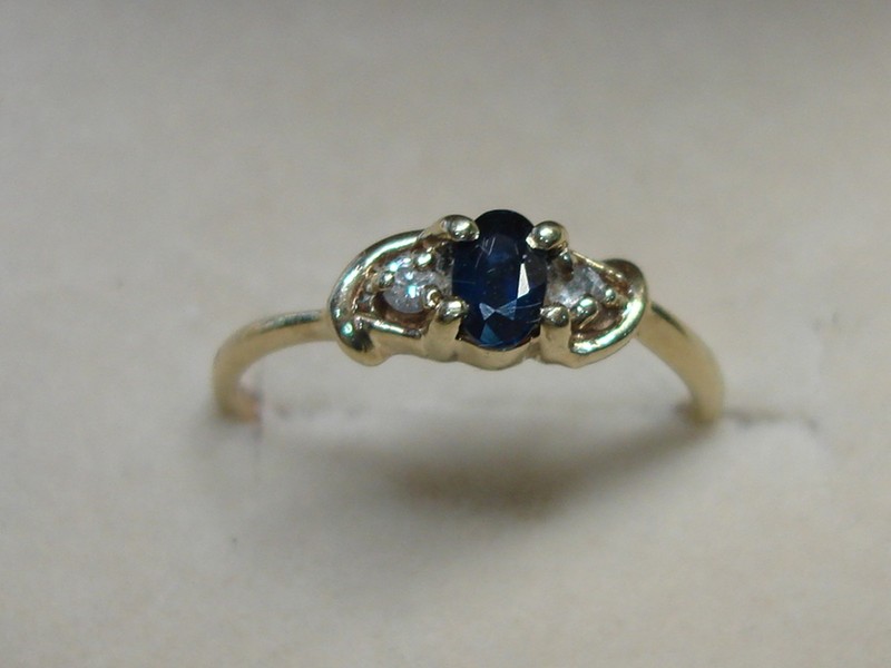 10K gold ring with oval sapphire and diamond accents, size 4.5