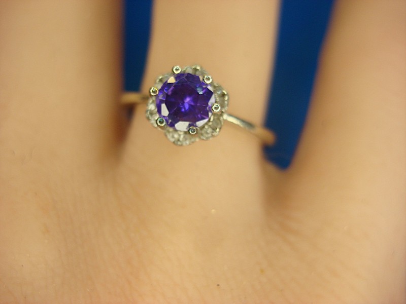 Sterling silver ring with a purple stone and diamond accents, size 7