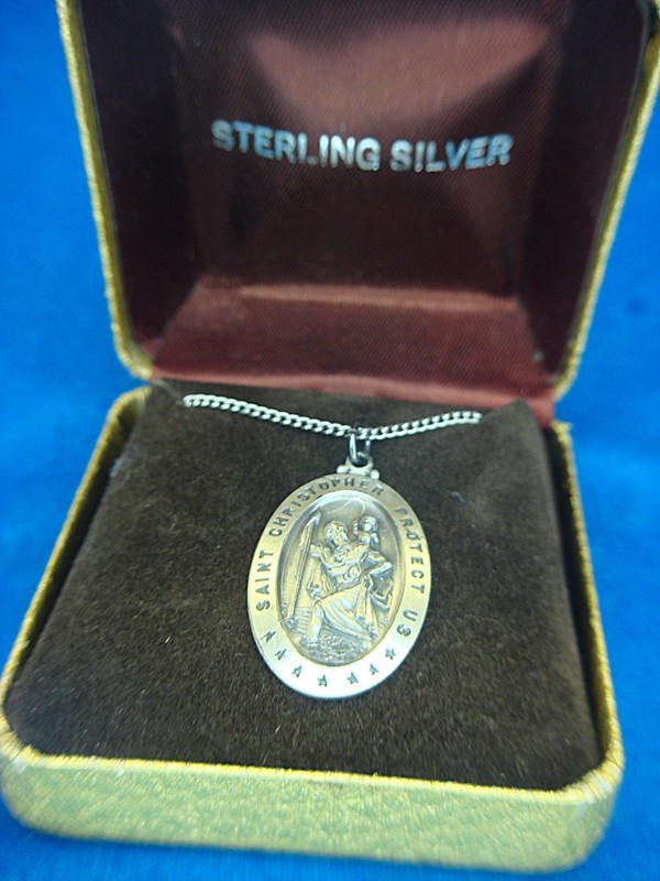 Polished sterling silver St. Christopher pendant with black detail and stainless steel chain