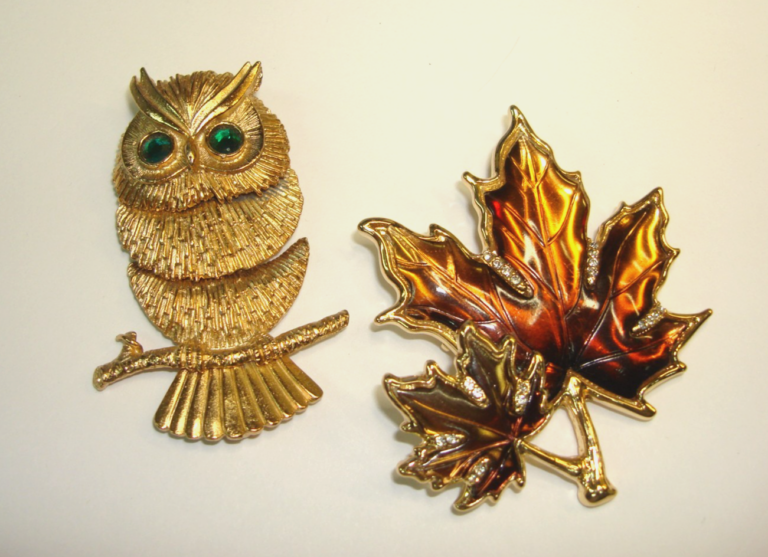 Pair of vintage Napier brooches: a maple leaf with rhinestones and an articulated owl with green rhinestone eyes.
