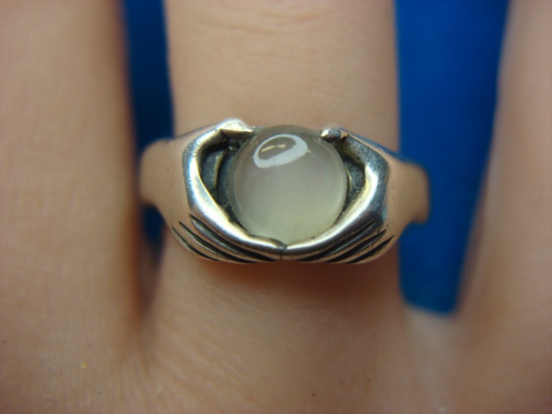 Sterling silver ring with unique hands grasping a frosted orb design, size 6.75