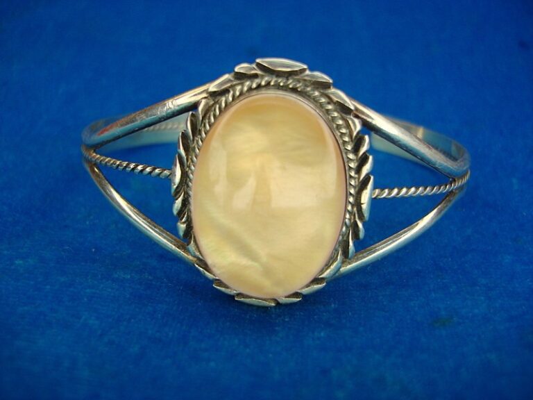 Navajo sterling silver cuff bracelet with orange abalone mother of pearl inlay