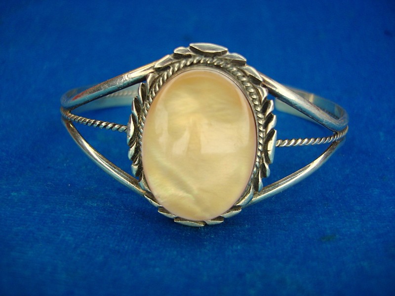 Navajo sterling silver cuff bracelet with orange abalone mother of pearl inlay