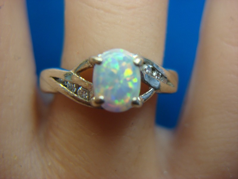 Sterling silver ring with an opal center stone and simulated diamonds